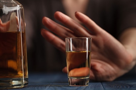 a photo of hand showing that the person wants no more drinks